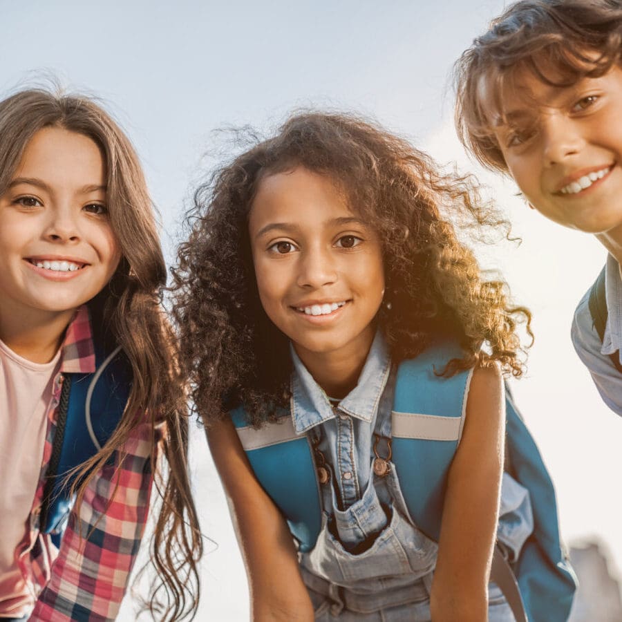 Portrait of school childrens smiling and looking in camera outdoors